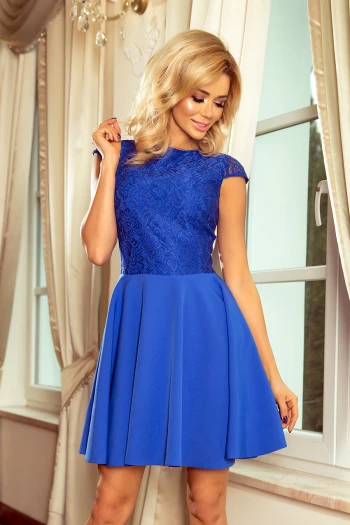 Modelka prezentuje elegancką sukienkę Livia, która zachwyca koronkową górą i rozkloszowanym dołem. Sukienka Livia w intensywnym niebieskim kolorze doskonale podkreśla sylwetkę, dodając stylu i klasy każdej okazji.